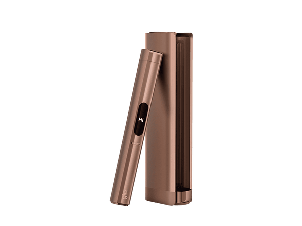 The glo™ HILO Plus, a sleek metallic rose gold device with a small display reading "Hi," rests against its matching rectangular case on a light background.