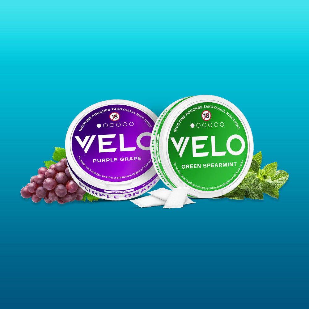 Two round cans labeled "FREE SAMPLE" are displayed on a blue gradient background, featuring the Product of the Year 2025 badge in Greece.