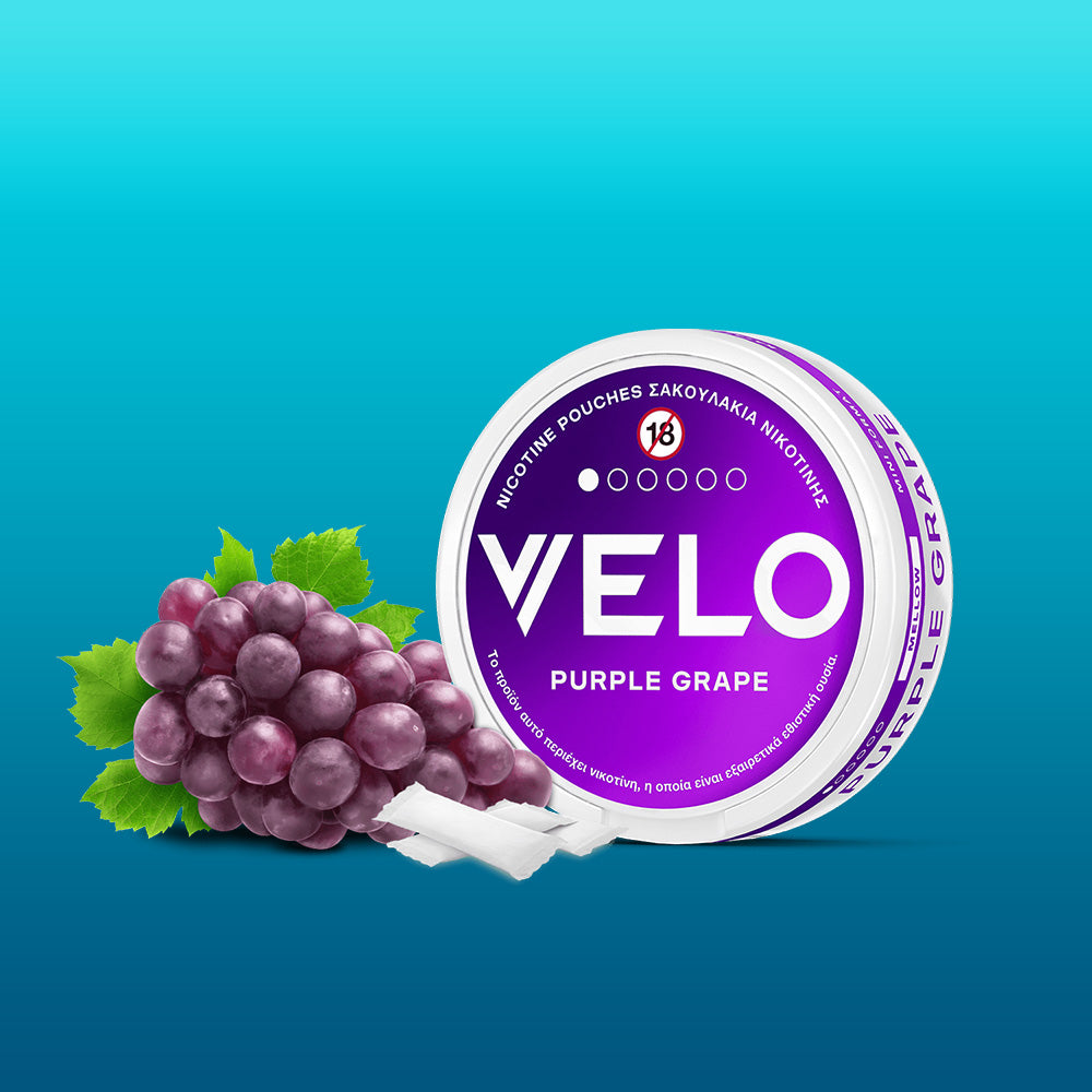 A FREE SAMPLE container sits beside a small bunch of purple grapes and three white pouches, all on a blue gradient background—proudly named Product of the Year 2025 in Greece.