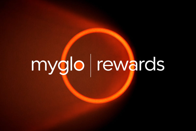 White text “myglo | rewards” appears over a glowing red-orange ring on a black background, with the ring casting a reddish glow to the left.
